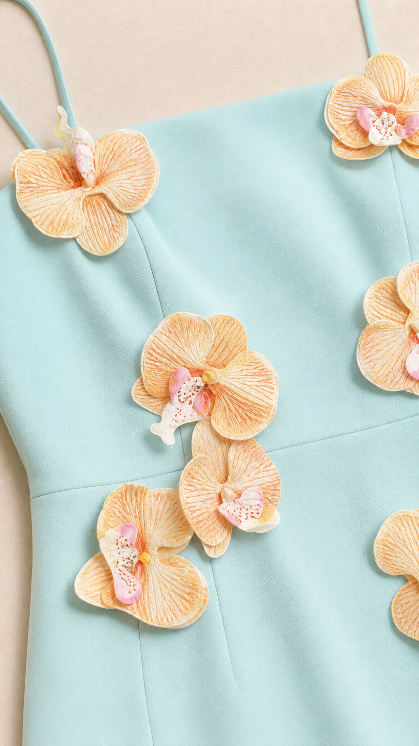 Close up of 3D floral appliques on light blue dress