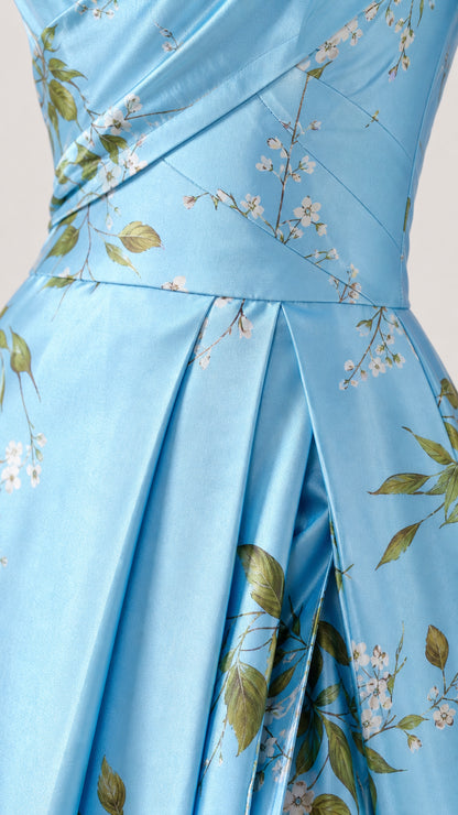 Close-up detail of pleated waist and floral print on Light Blue satin dress