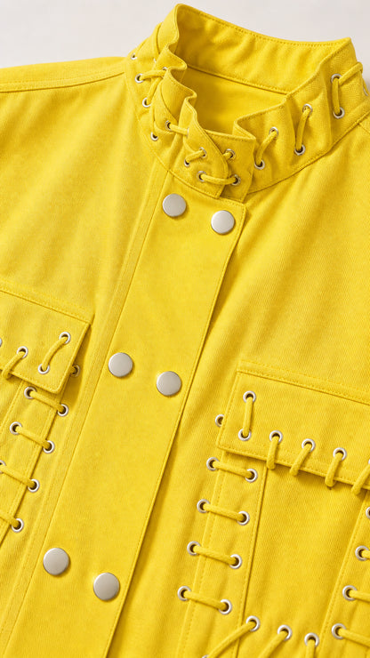 Close-up detail of yellow vest showcasing lace-up stand collar and metal snap buttons