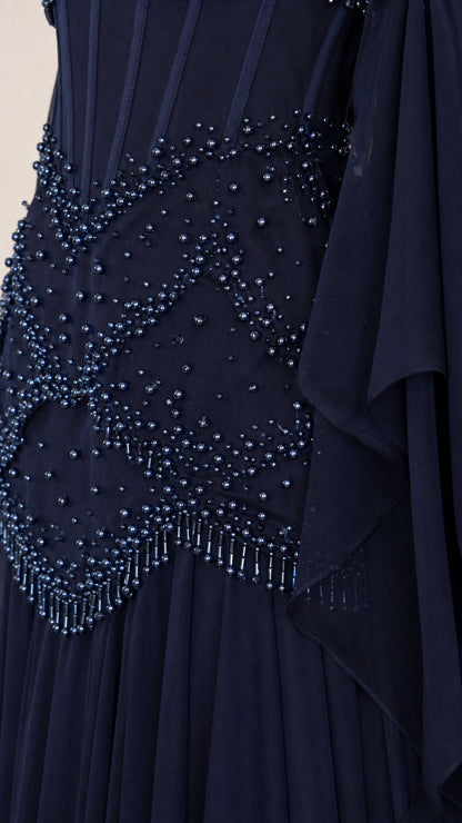 Close-up of intricate beadwork on the bodice of the navy evening gown
