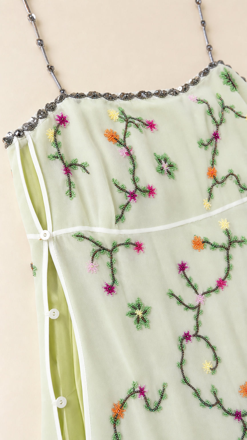 Close-up of beaded straps and embroidery details on sage dress