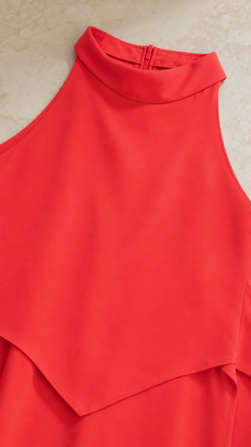 Close-up of mock neck collar and layered bodice detail in red