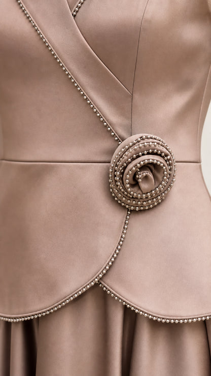 Close-up detail of beaded trim and dimensional rosette waist accent