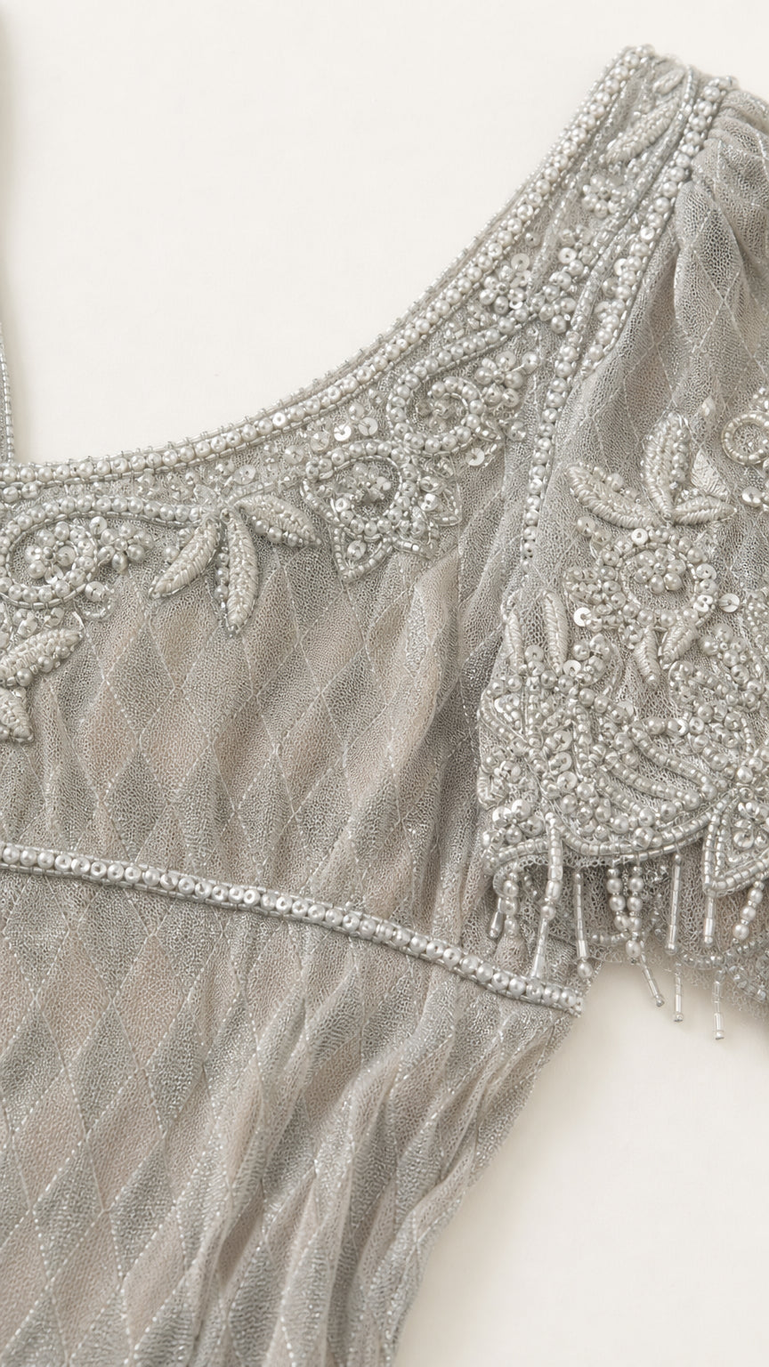 Close-up detail of beaded embroidery on neckline and short sleeve