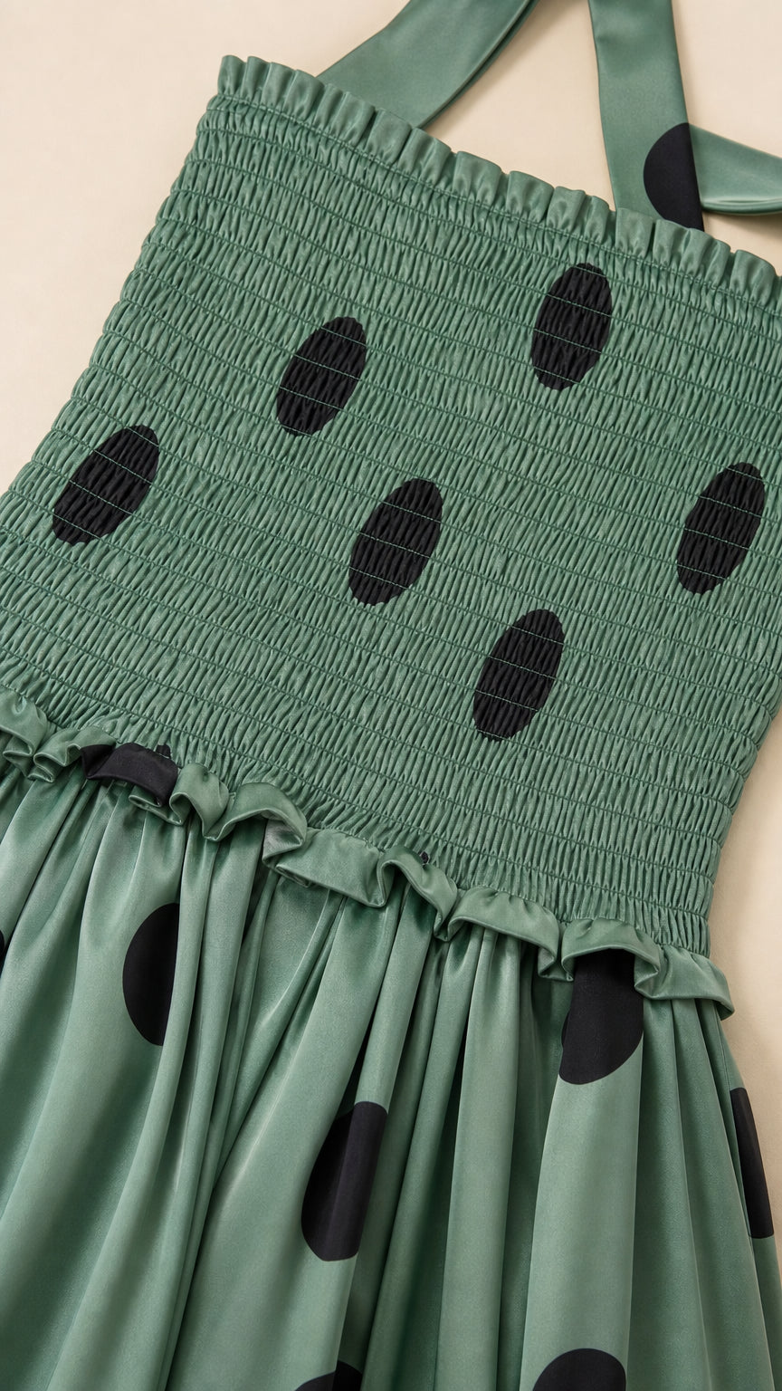Close-up detail of smocked bodice and polka dot fabric