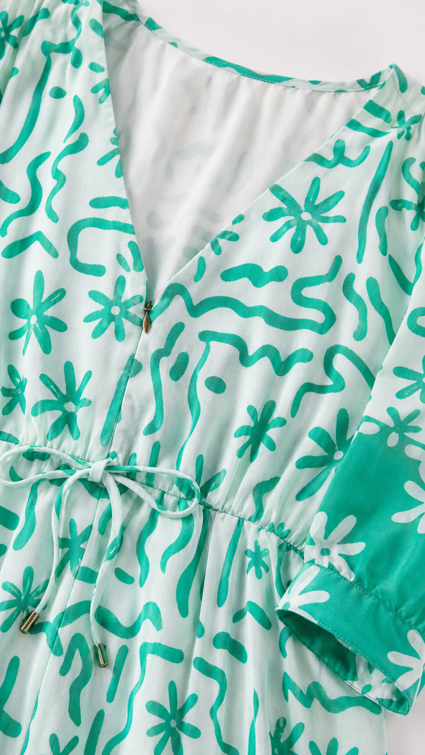 Close-up detail of V-neck and drawstring waist