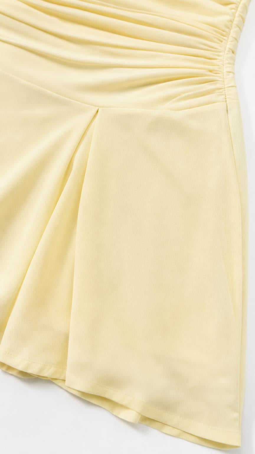 Close-up view of the fabric texture and side ruching detail on the yellow dress