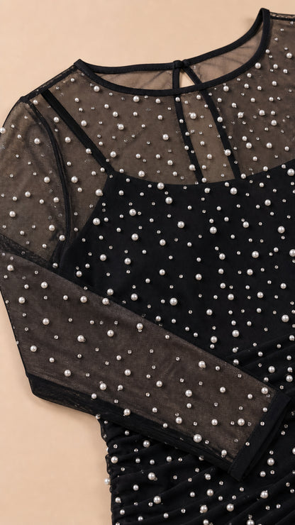 Close-up detail of sheer mesh and faux pearl neckline and sleeve
