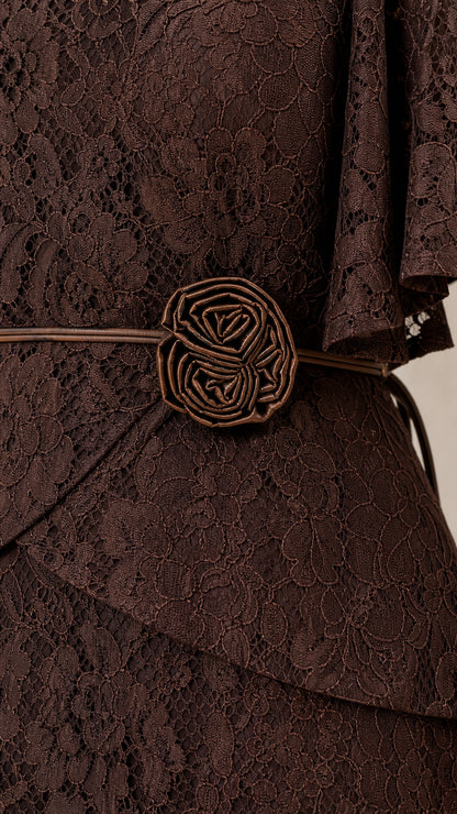 Close-up of waist rosette belt on brown lace dress