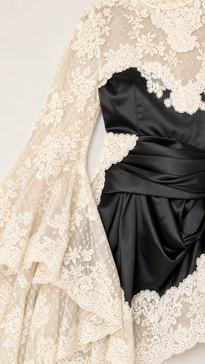 Close-up detail of lace sleeve and black satin bodice contrast