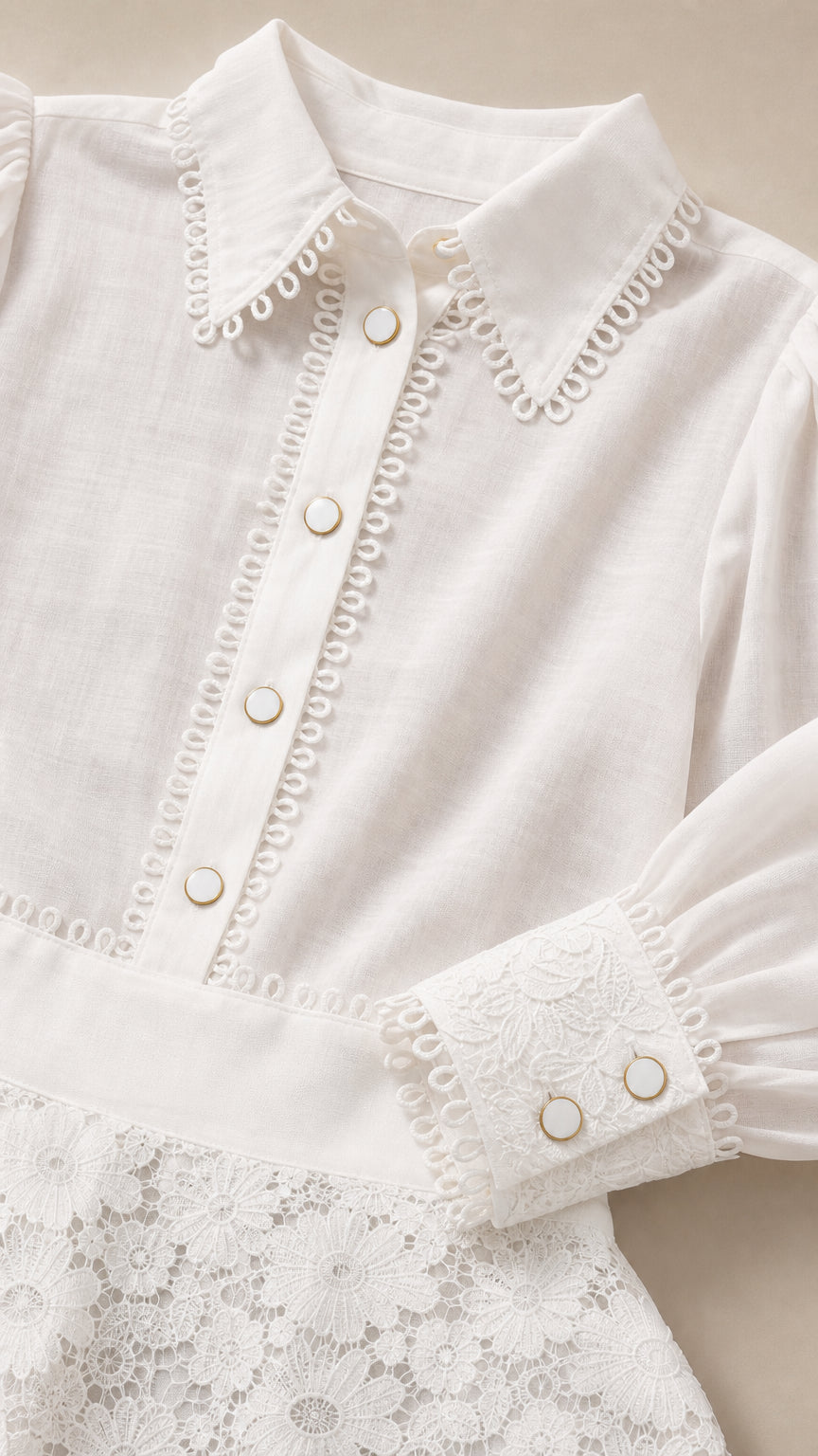 Close-up detail of white blouse collar, buttons, and lace skirt