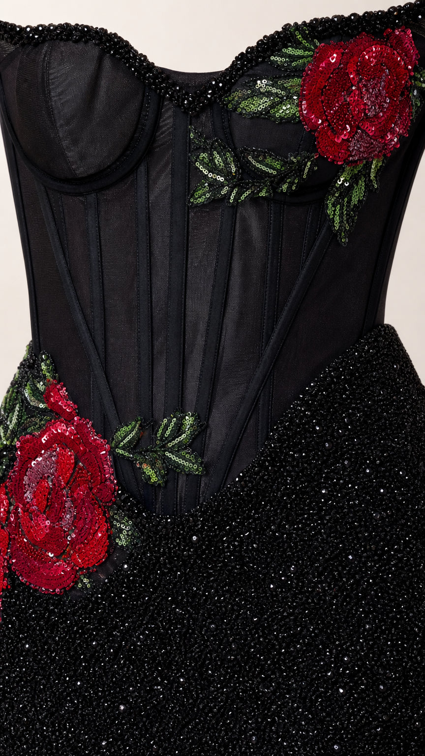 Close-up detail of red rose embroidery and corset boning