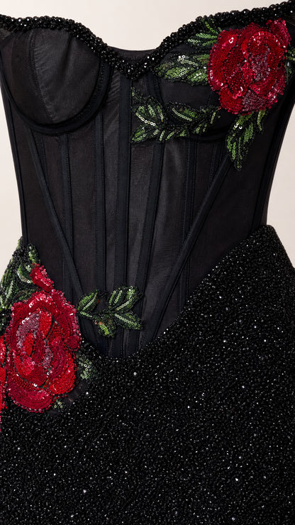 Close-up detail of red rose embroidery and corset boning