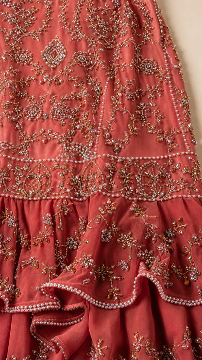 Close-up detail of intricate bead and pearl embellishments on the skirt
