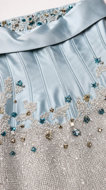 Close-up of crystal and bead embellishments on light blue gown