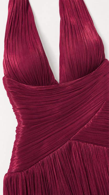 Close-up detail of burgundy plunging halter neckline and cross-ruched waist