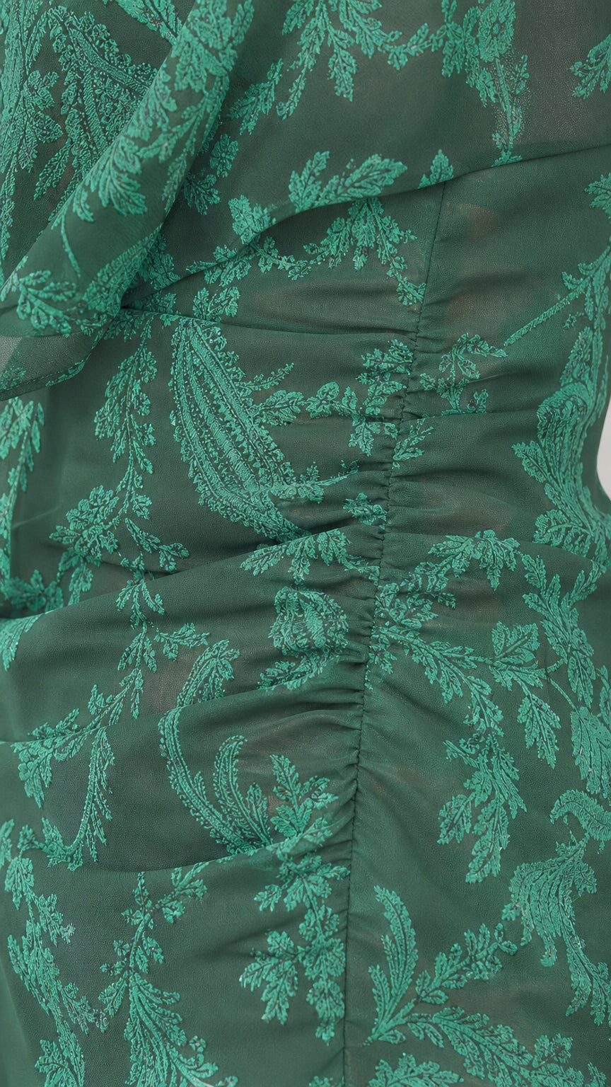 Close-up detail of green botanical jacquard fabric texture and side gathering