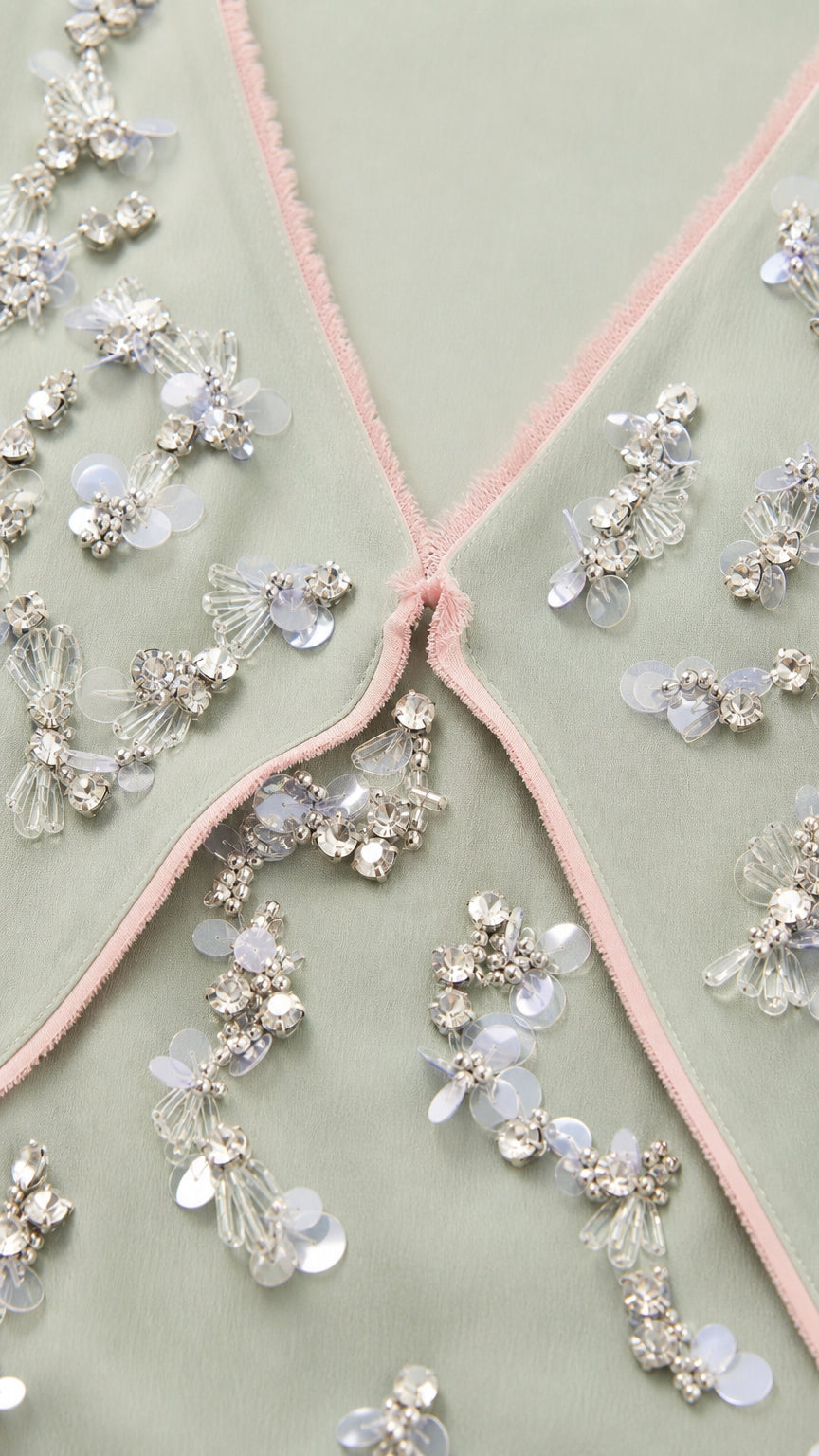 Close-up of beaded floral embroidery and contrast piping