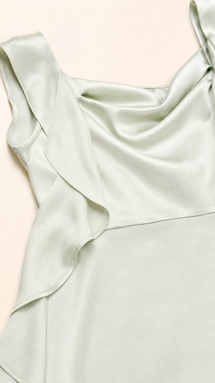 Close-up of cowl neck and ruffle strap detail on sage green dress