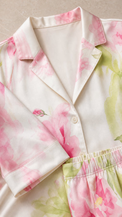 Close-up detail of notch lapel collar and cuff on ivory floral satin shirt