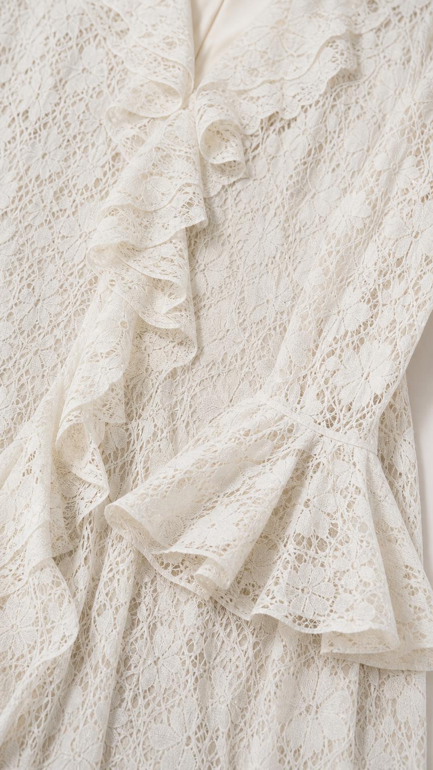Close-up detail of lace texture and cascading ruffles on white dress