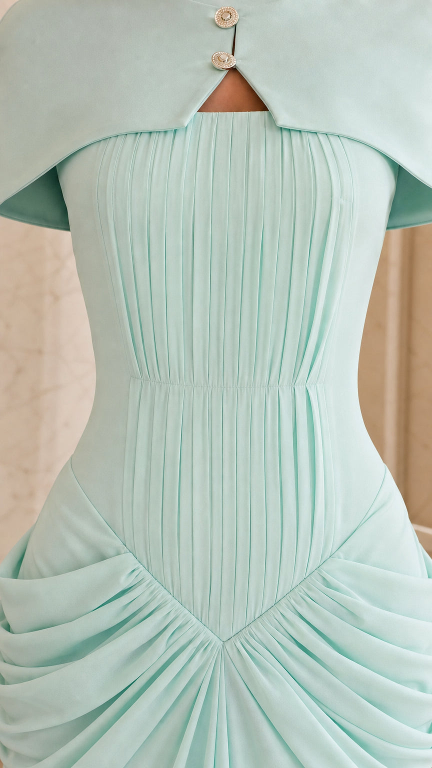 Closeup detail of button keyhole neckline and bodice pleats