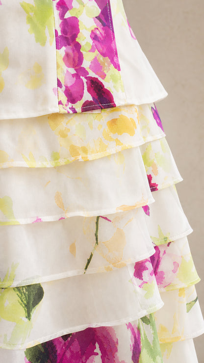 Close up view of delicate sheer tiered fabric detailing and floral print