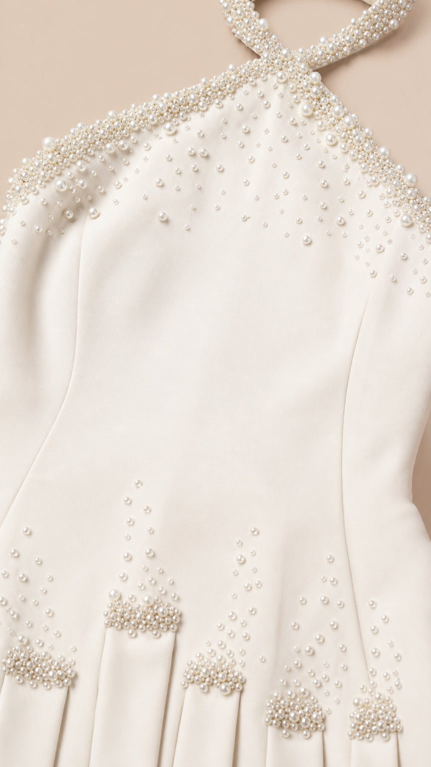 Close-up detail of the pearl-embellished halter neckline and bodice
