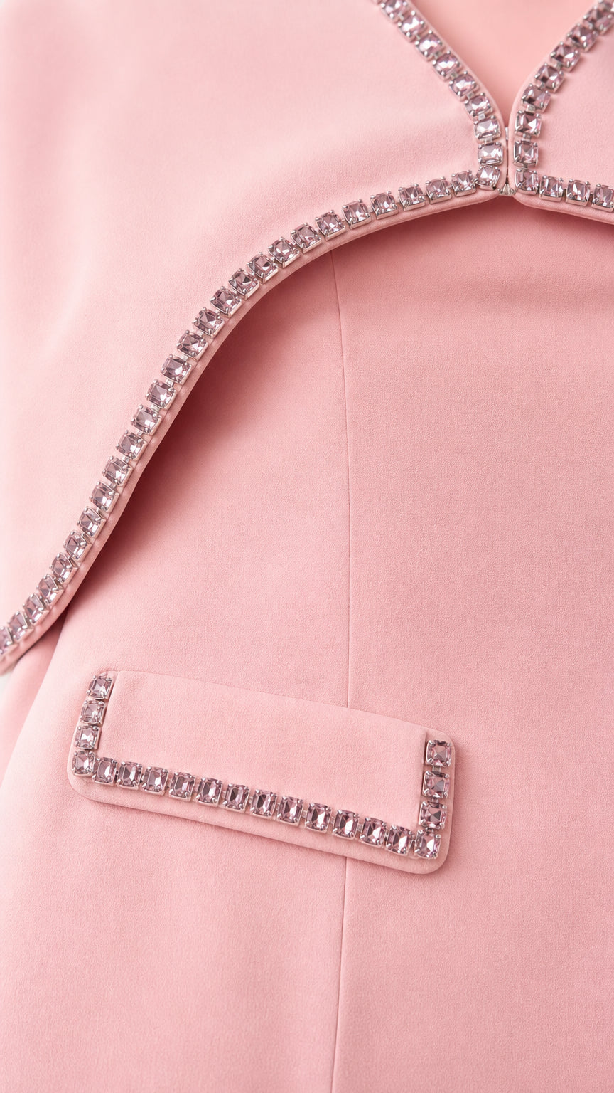 Close-up detail of rhinestone trim and pocket flap on pink dress