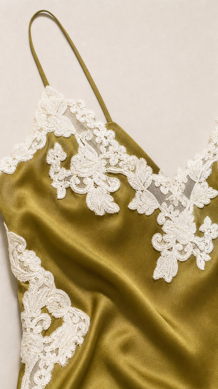 Close-up of lace applique on olive satin dress