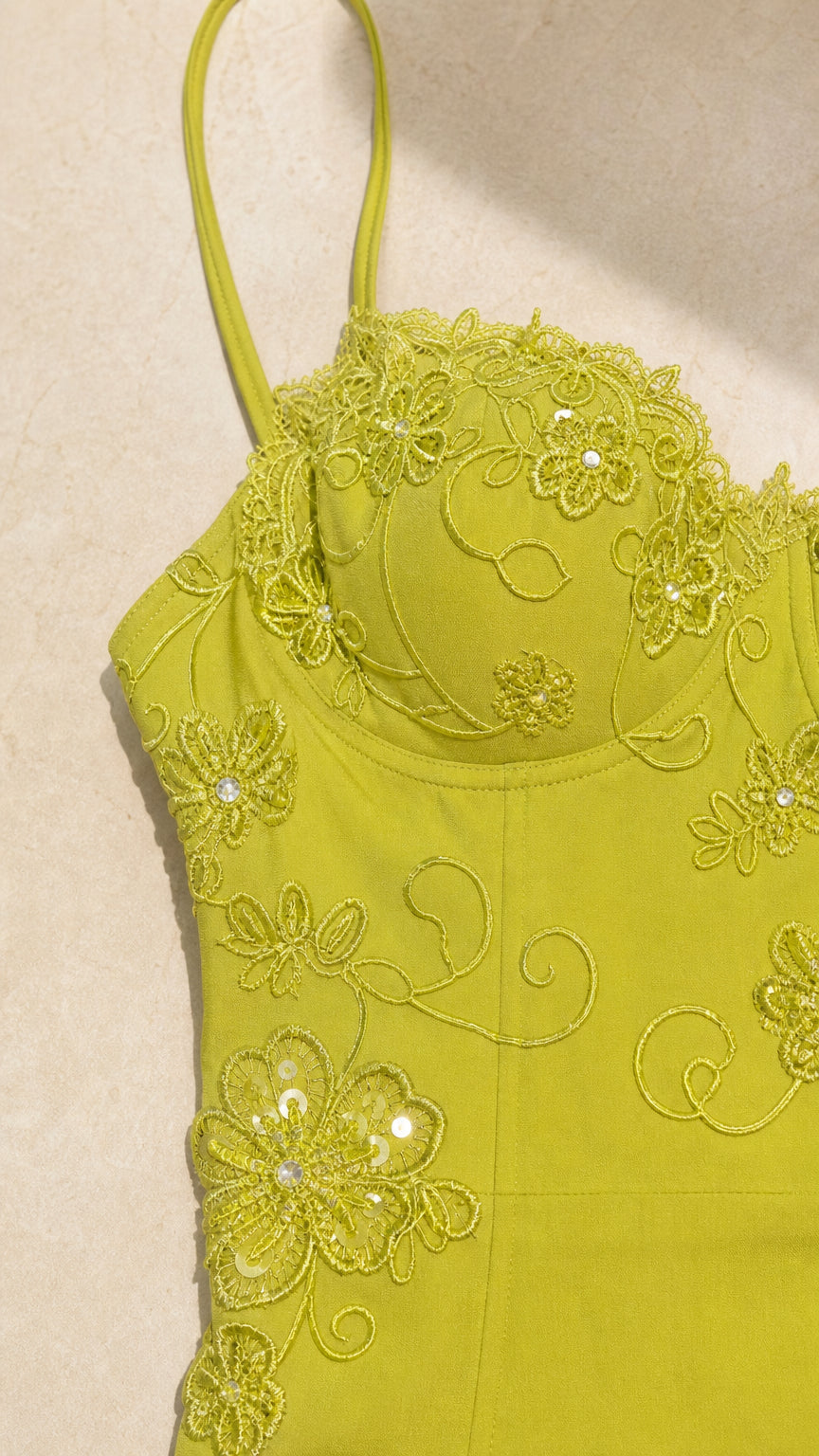 Close-up detail of bustier cup design with floral lace embroidery and subtle sequins in lime green