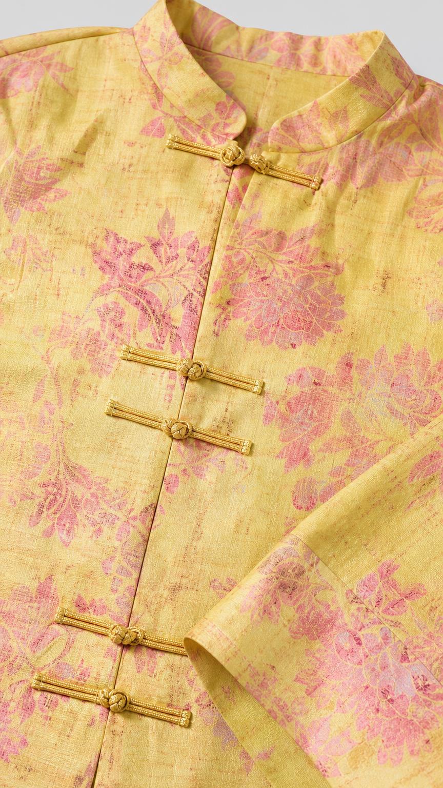 Close-up detail of yellow brocade fabric and knot buttons