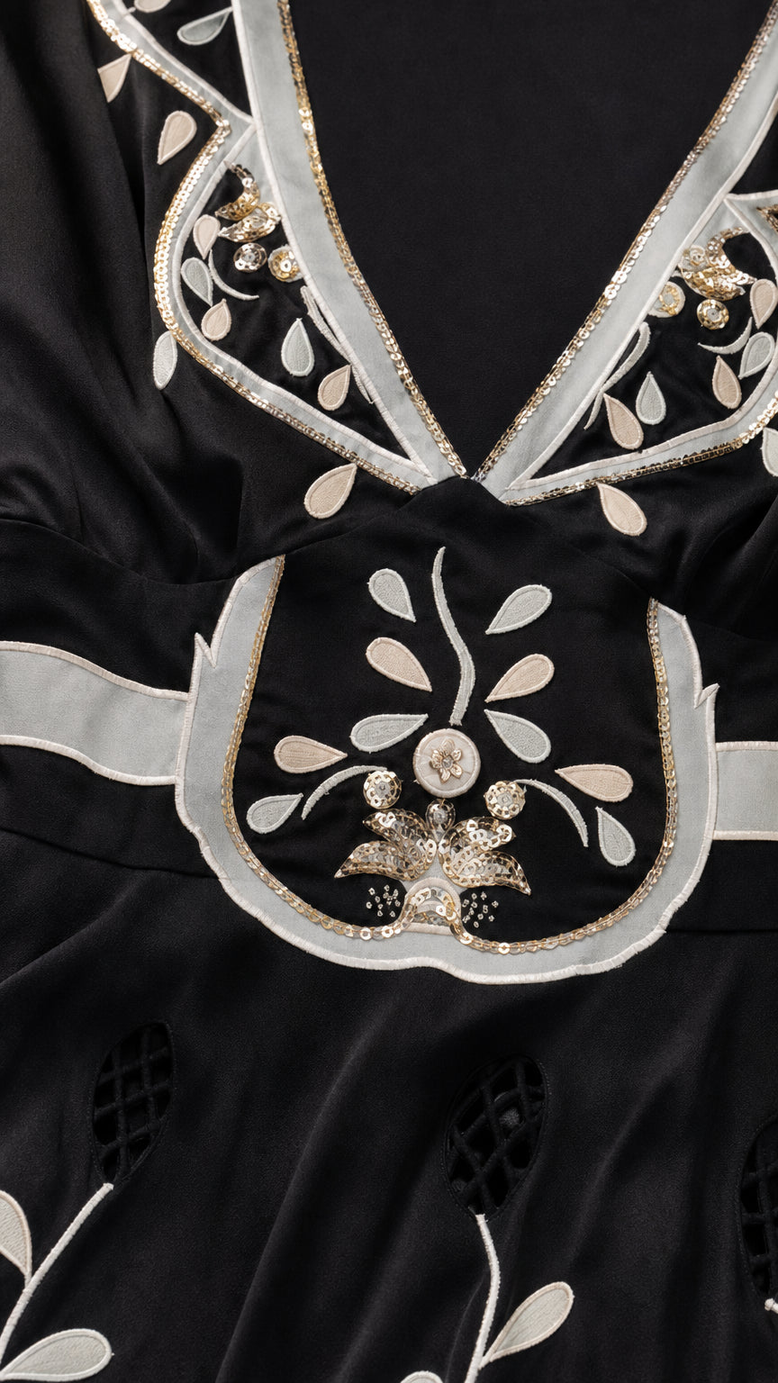 Close-up detail of neckline embroidery and beadwork