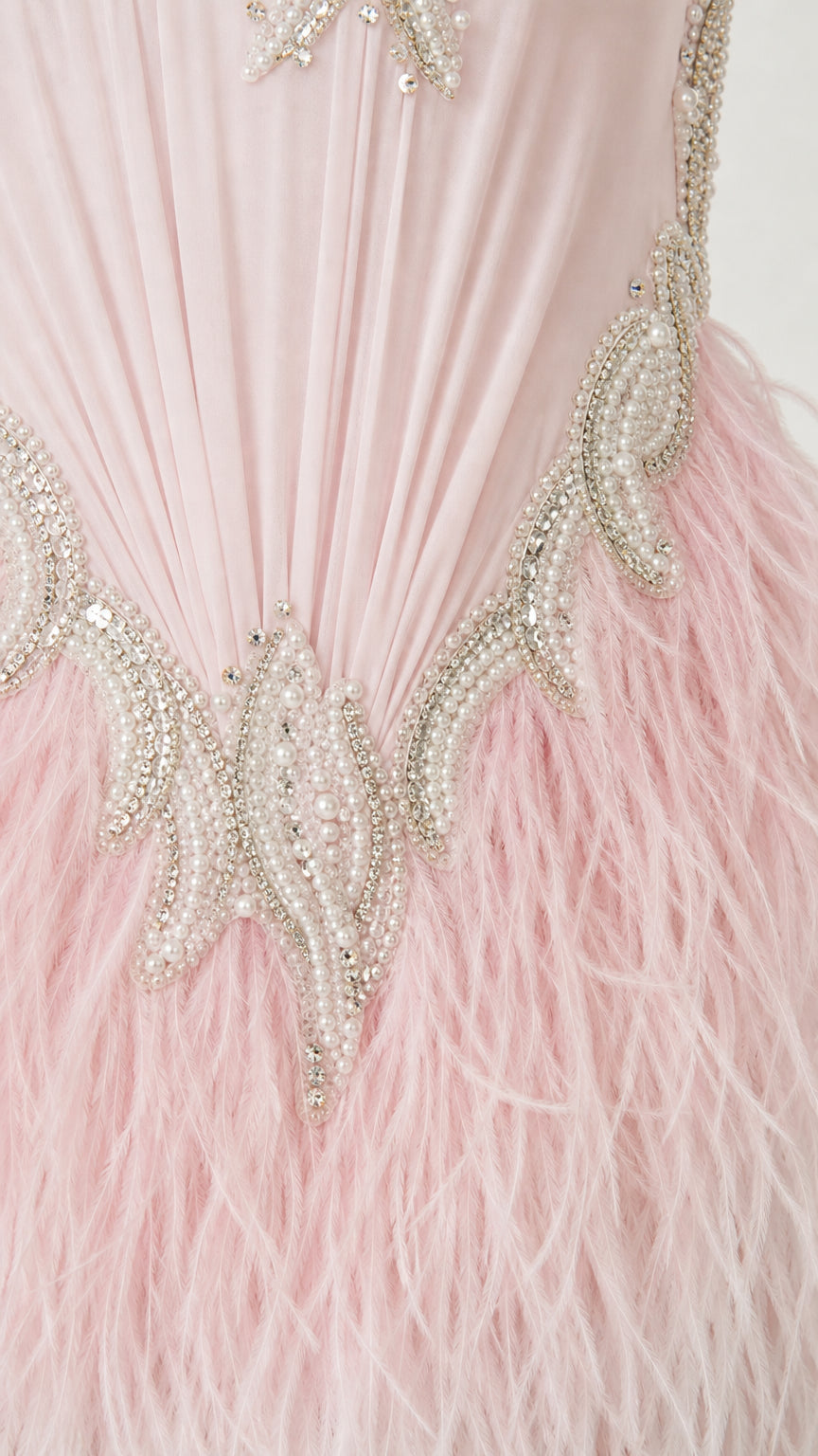Close-up of beaded waist embroidery and soft feather skirt detailing