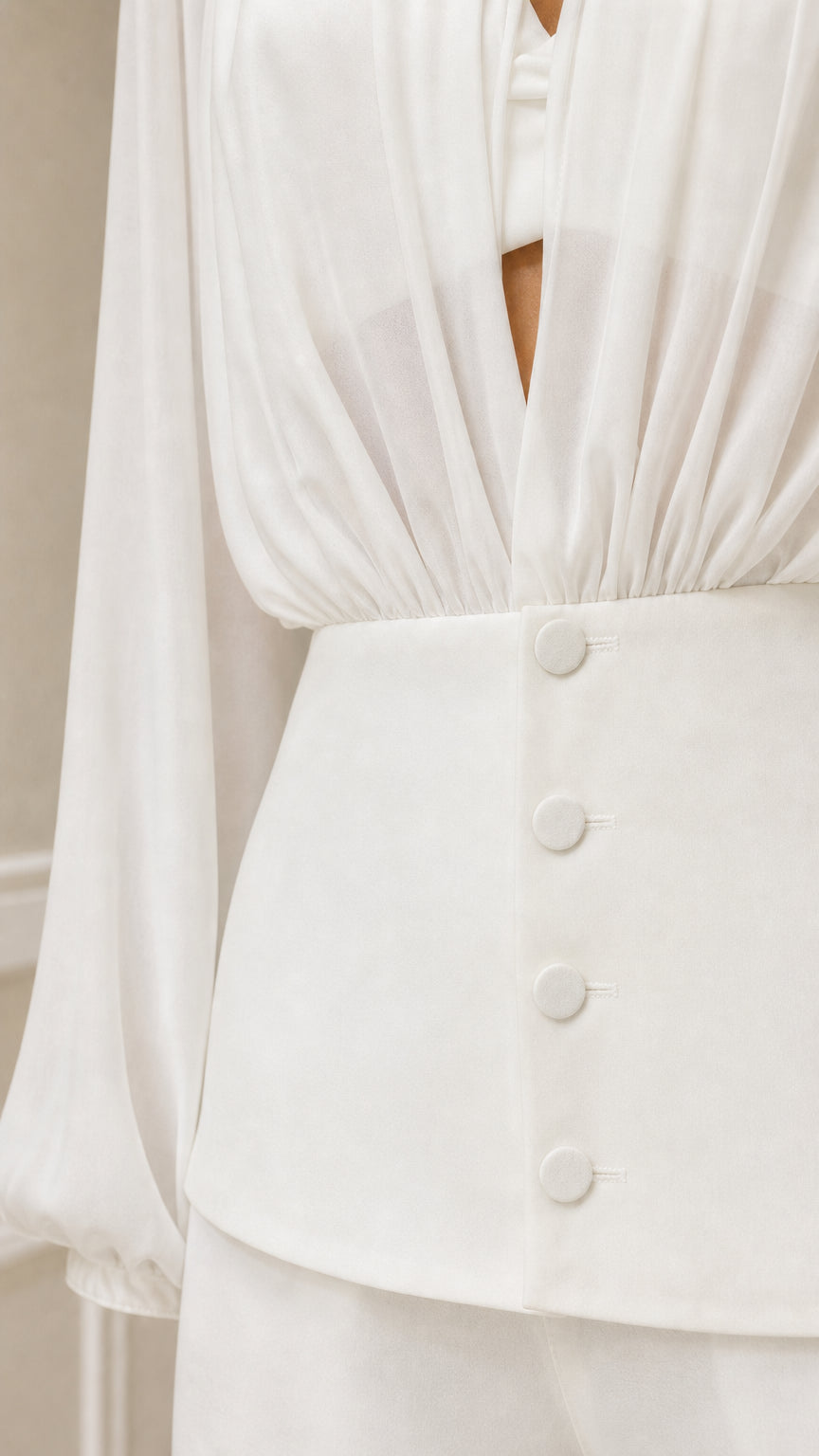 Close up of white blouse button down waist and gathering detail