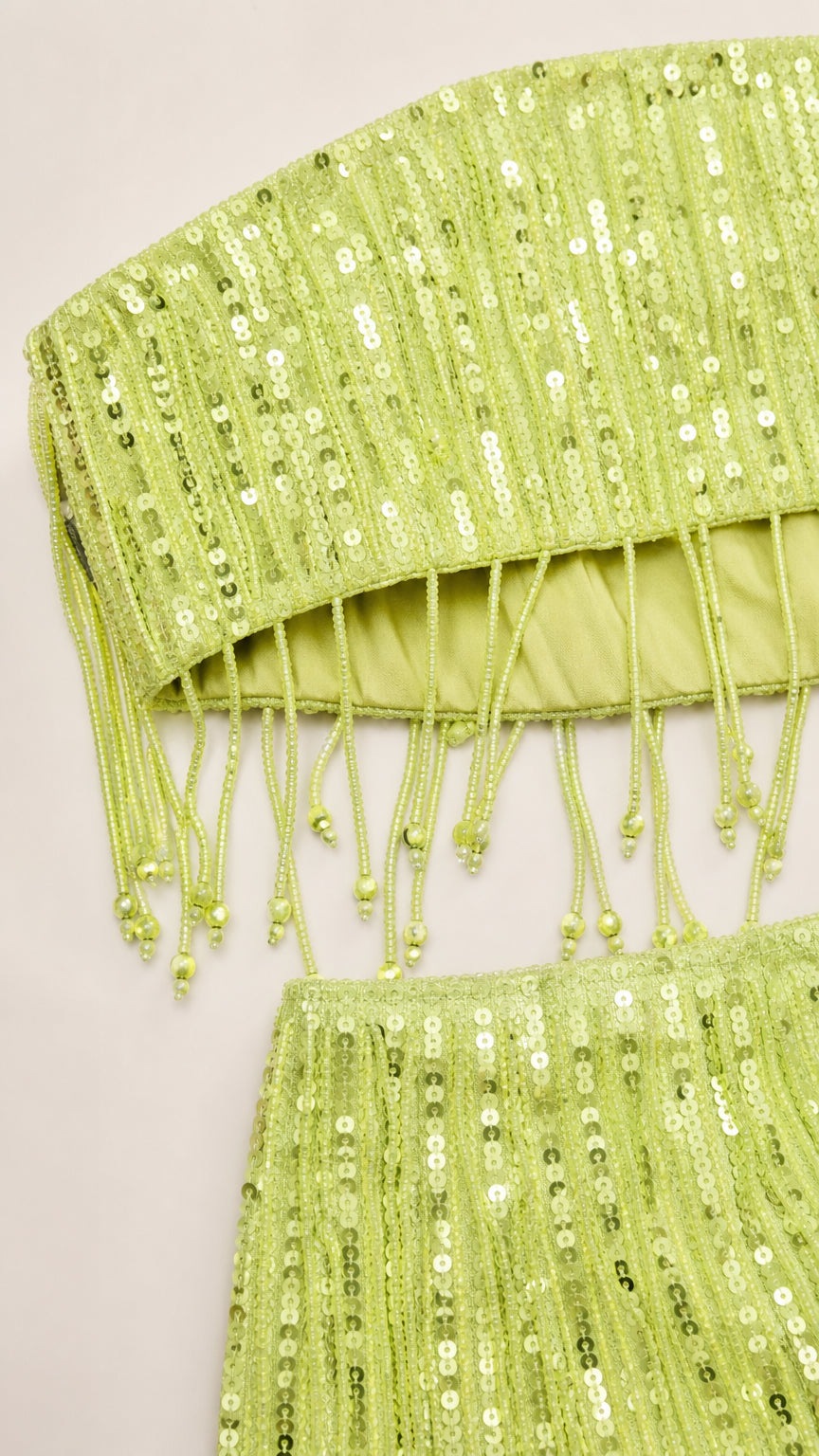 Close up detail of lime green sequin crop top and skirt