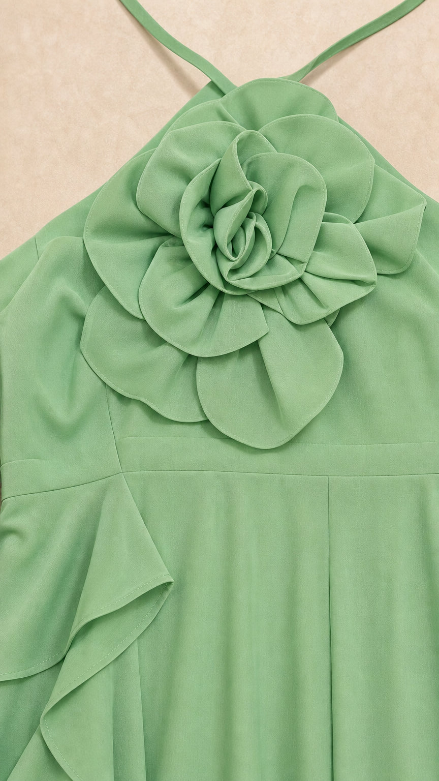 Close-up detail of the 3D fabric flower applique on halter neckline