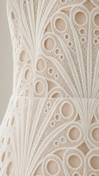 Close-up detail of the intricate circular embroidered lace fabric and texture