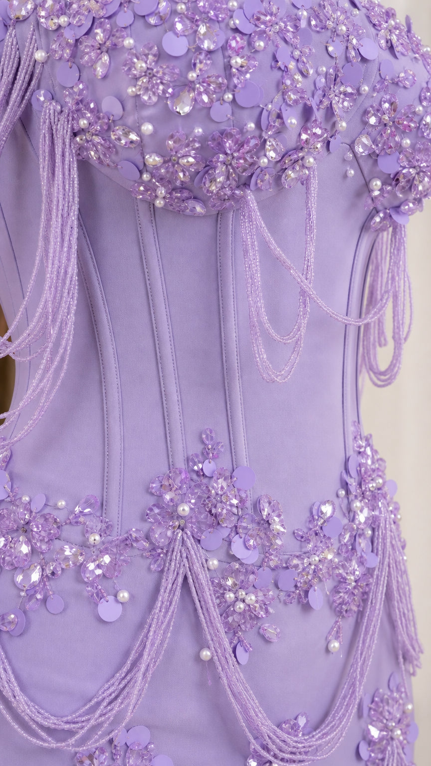 Close-up detail of structured bodice, floral beadwork, and draping