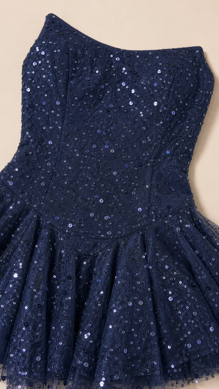 Close up of navy sequin fabric and bodice details