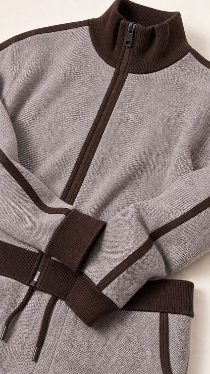 Close-up detail of textured knit fabric, zipper, and ribbed contrast trim