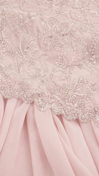 Close-up detail of delicate floral sequin embroidery on bodice hem