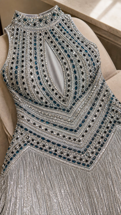Close-up detail of silver beaded bodice featuring high collar and teardrop keyhole cutout