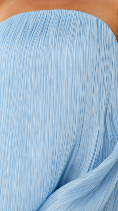 Close-up of fine accordion pleat texture on light blue dress fabric