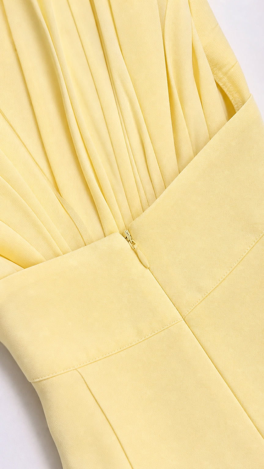 Close-up of pleated bodice and side zipper detail on yellow dress