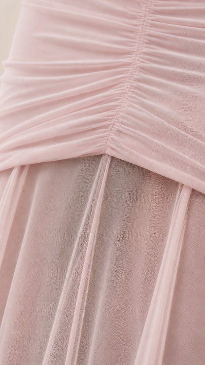 Close-up detail of bodice ruching and sheer mesh skirt layer