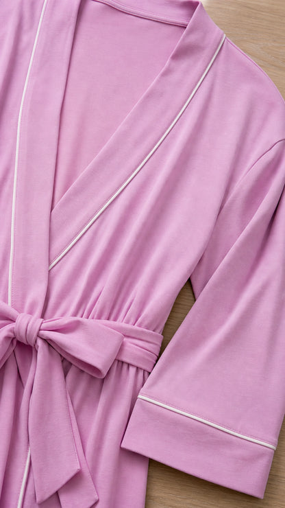 Close-up detail of lilac robe showing contrast white piping, soft knit texture, and tied sash