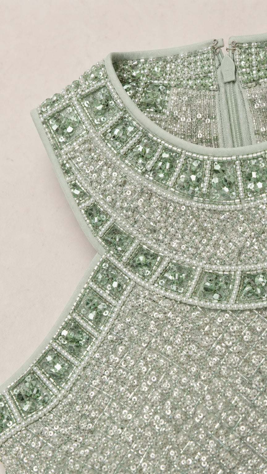Close-up detail of sequin and bead embellishments on the neckline