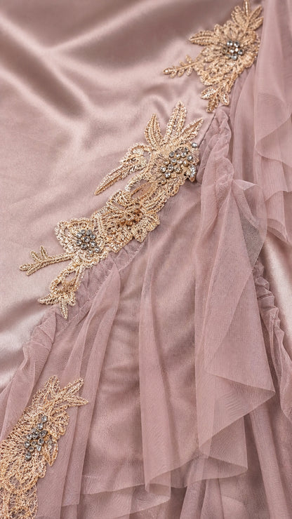 Close-up detail of golden floral lace embroidery and sheer tulle ruffles