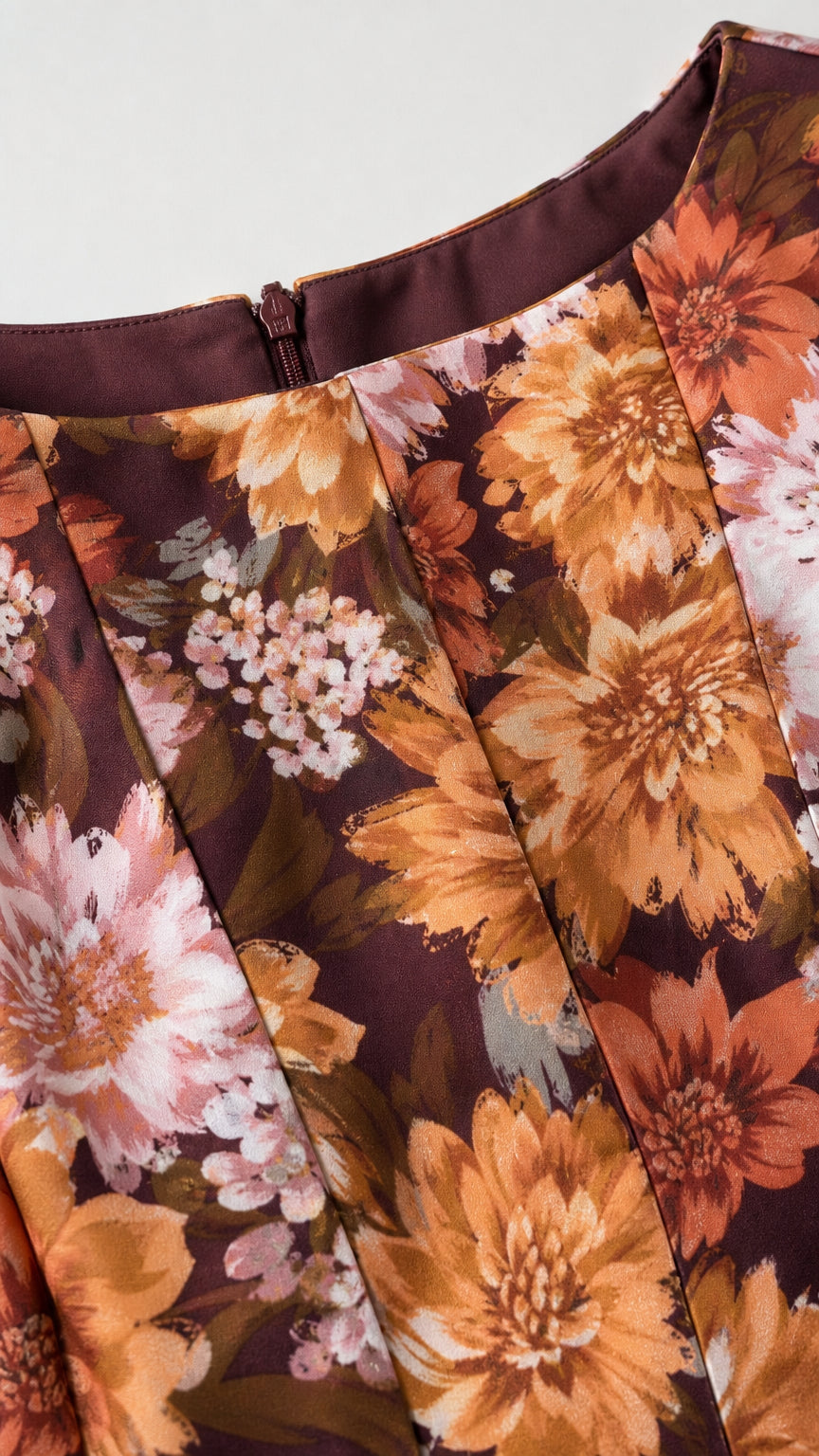 Close-up of burgundy floral dress fabric and side zipper detail